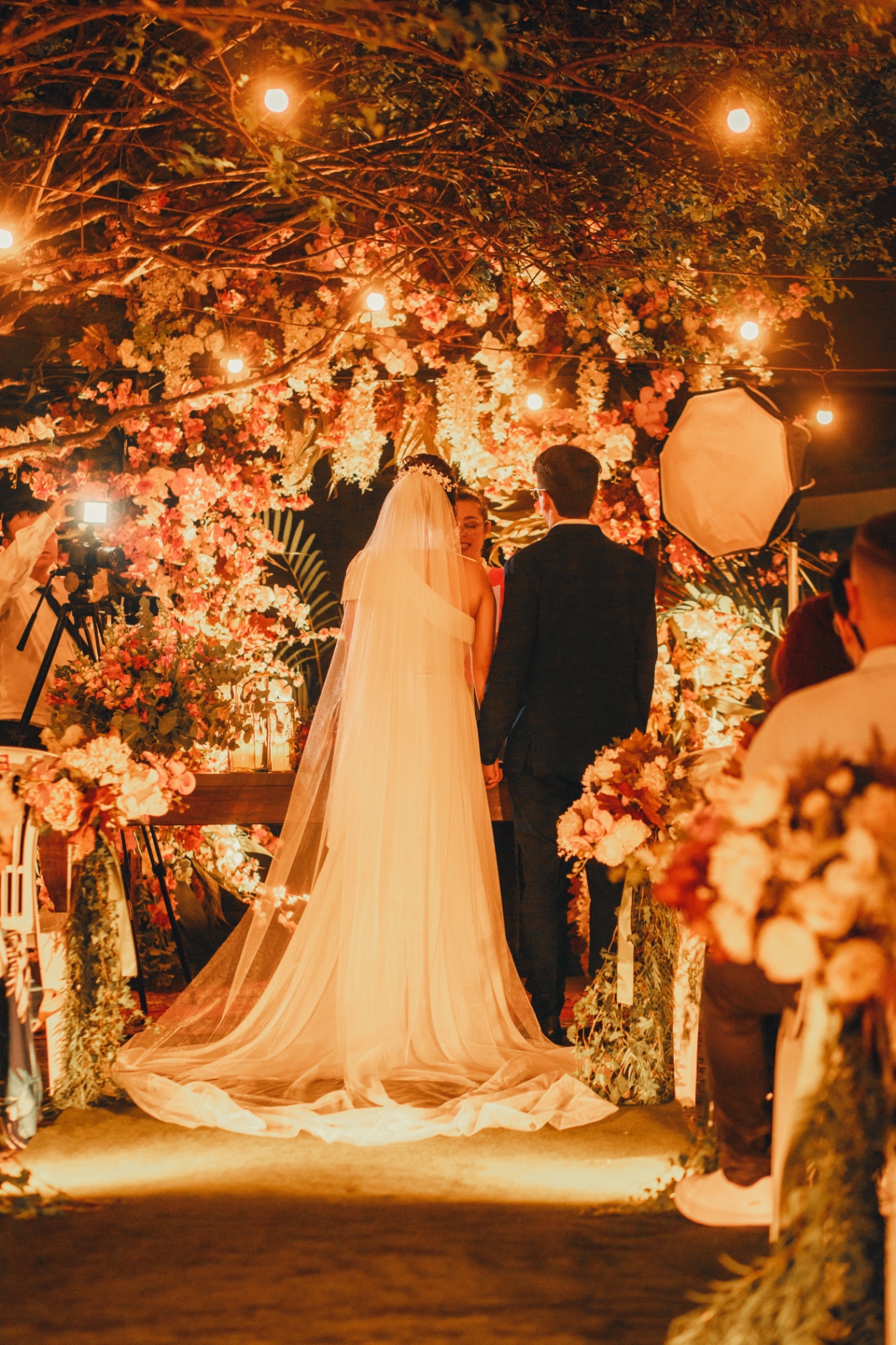 Wedding florist arranging an editorial arrangement in a bright studio